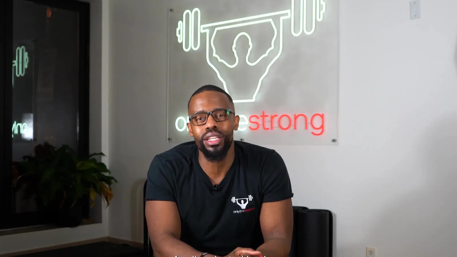 Daniel Smith, owner of onlythestrong, speaking to camera in the studio